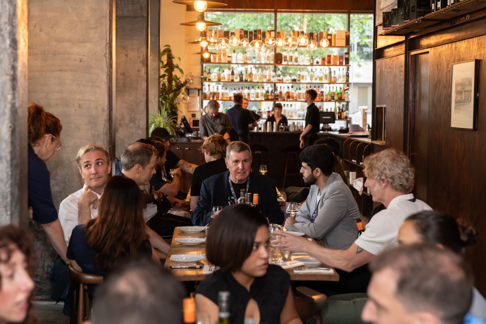 A SEG3 speaker dinner - guests seated at long tables in an intimate restaurant setting
