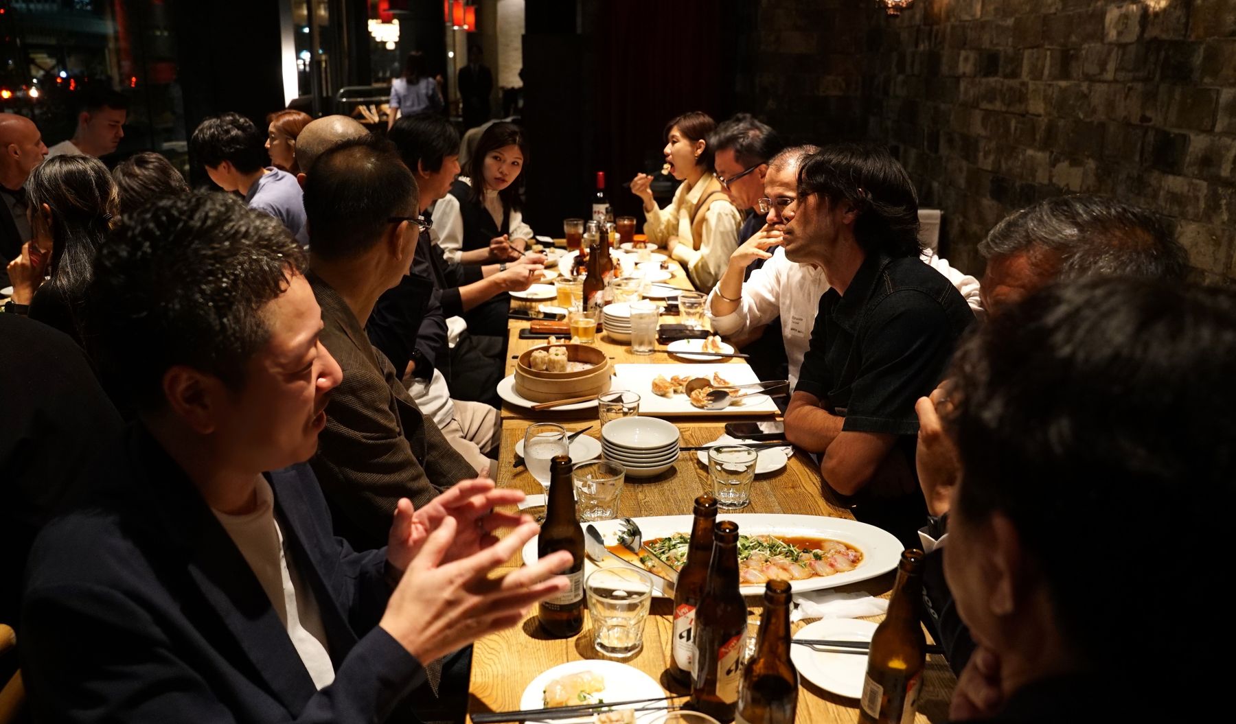 Executives seated along a long dinner table at the SEG3 Supper Club Tokyo